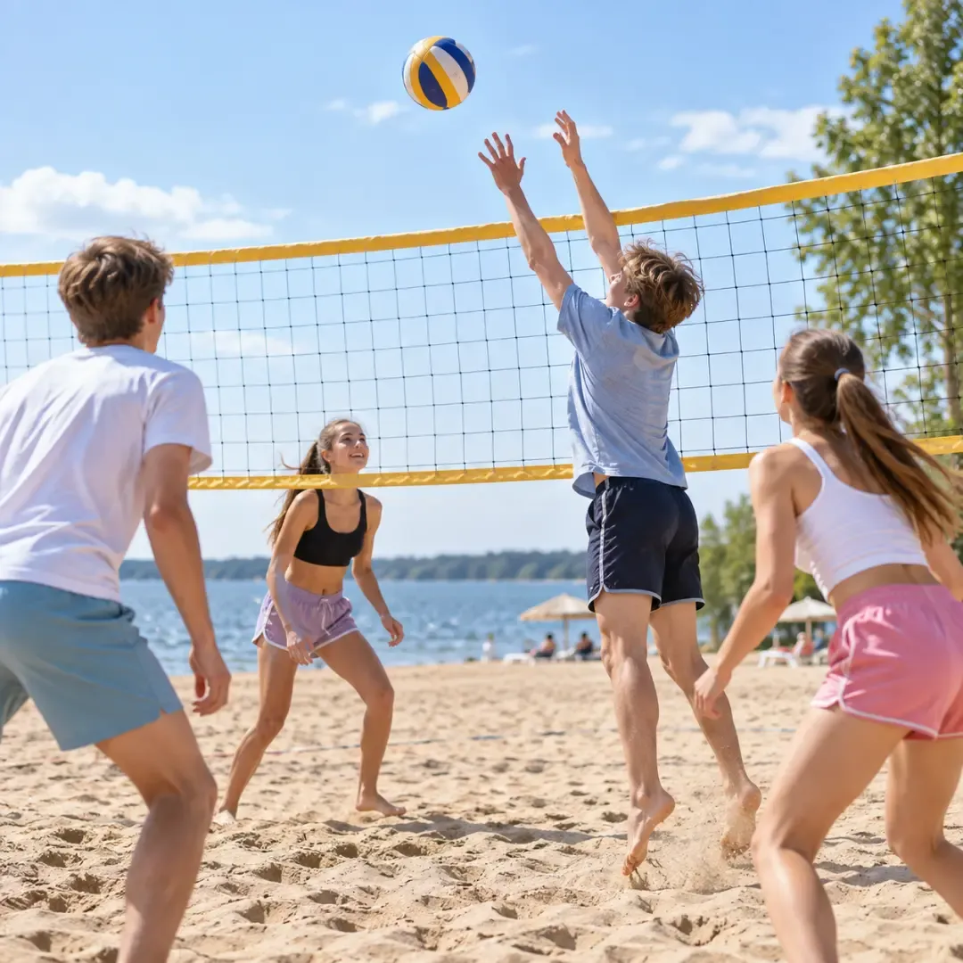 Teenagers playing beach volleyball on a sunny summer day.