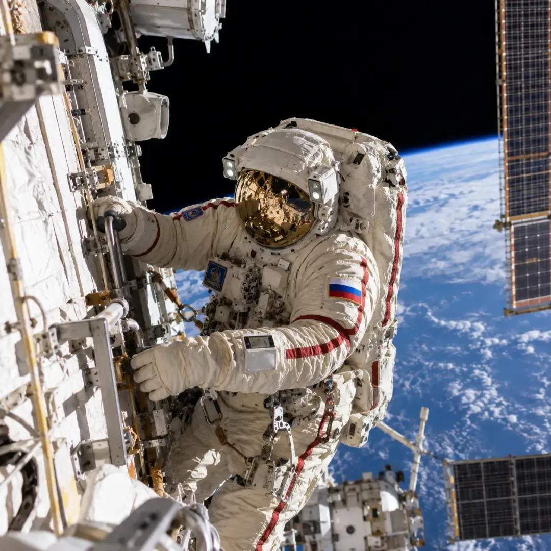 Russian cosmonaut performing a spacewalk outside the International Space Station.